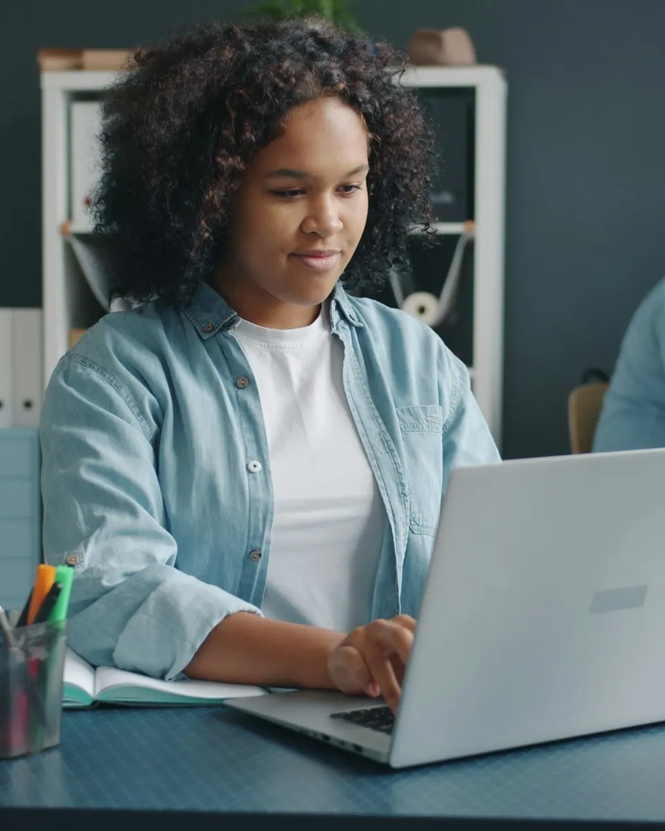 A researcher working on a laptop in an office